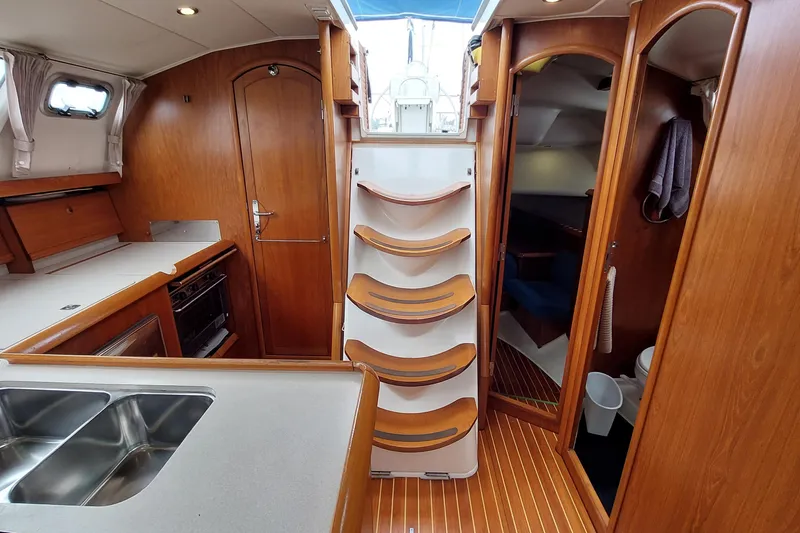 Slide: The Image of Interior of 2002 Jeanneau Sun Odyssey 43 DS sailboat with wooden cabinetry and compact kitchen. - 58