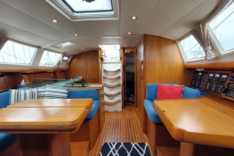 Slide: The Image of Interior of 2002 Jeanneau Sun Odyssey 43 DS sailboat with wood finish and blue seating. - 59