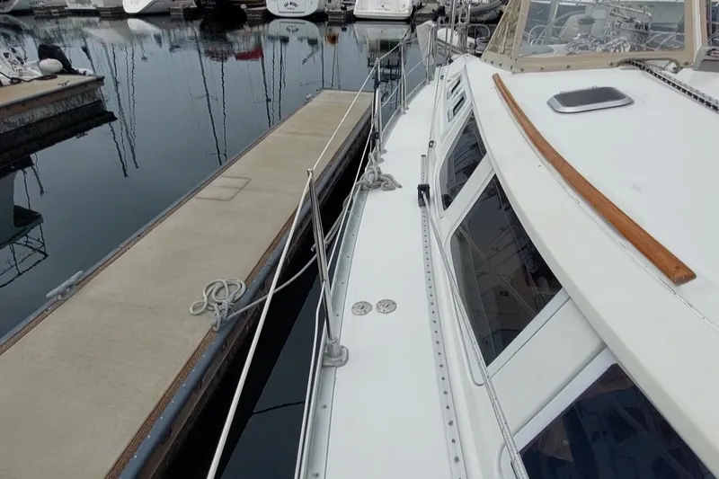 Slide: The Image of Jeanneau Sun Odyssey 43 DS sailboat docked at marina, side view, 2002 model. - 6