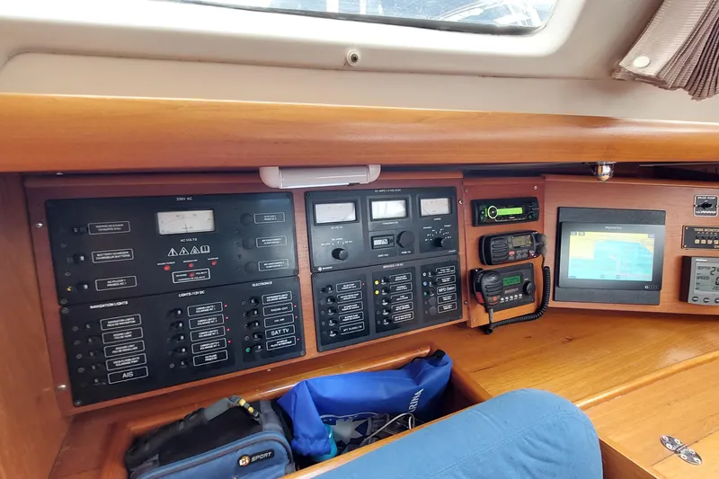Slide: The Image of Control panel of a 2002 Jeanneau Sun Odyssey 43 DS sailboat, featuring navigation and communication equipment. - 61
