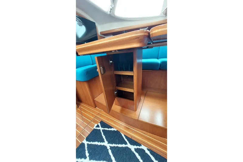 Slide: The Image of Interior of 2002 Jeanneau Sun Odyssey 43 DS with wooden cabinetry and blue seating. - 65
