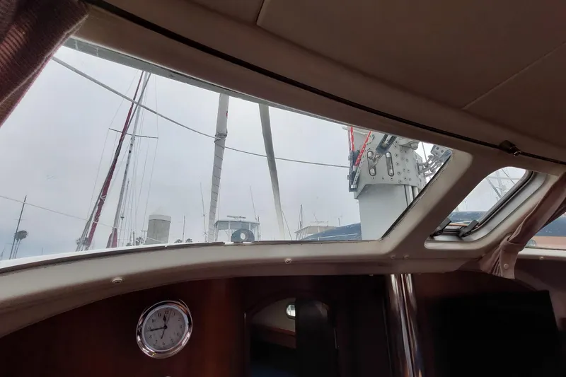 Slide: The Image of Interior view of 2002 Jeanneau Sun Odyssey 43 DS sailboat, showcasing cabin windows and clock. - 67