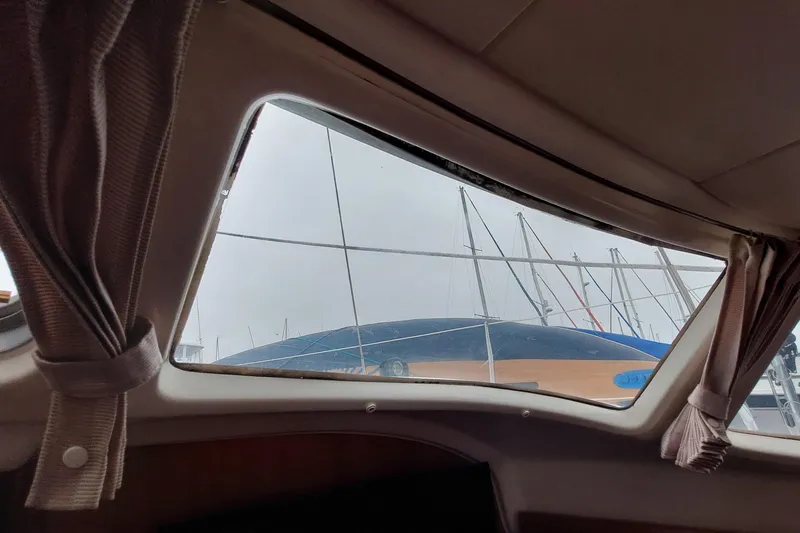 Slide: The Image of Interior view from Jeanneau Sun Odyssey 43 DS, showing marina and sailboat masts outside. - 68