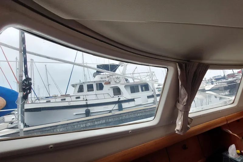 Slide: The Image of View from inside a 2002 Jeanneau Sun Odyssey 43 DS, overlooking marina boats. - 70