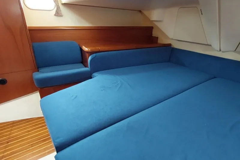 Slide: The Image of Interior of 2002 Jeanneau Sun Odyssey 43 DS with blue seating and wooden accents. - 73