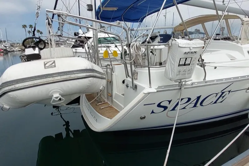 Slide: The Image of Jeanneau Sun Odyssey 43 DS sailboat, 2002 model, docked with inflatable dinghy attached. - 9