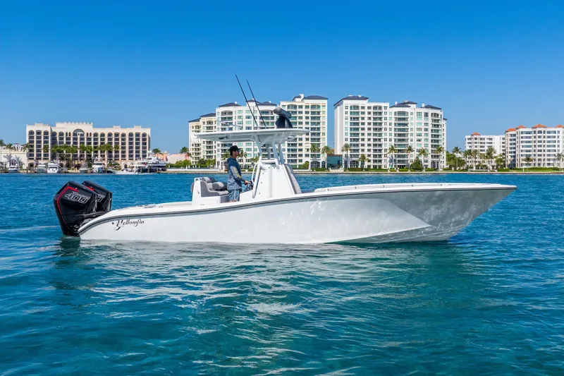 The Image of 2014 Yellowfin 29 Offshore boat cruising near waterfront buildings. - 0
