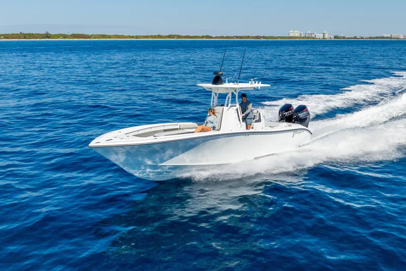 Slide: The Image of 2014 Yellowfin 29 Offshore boat cruising on open blue water. - 2