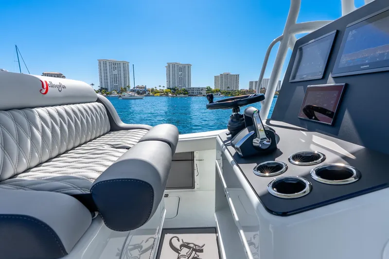 Slide: The Image of 2014 Yellowfin 29 Offshore boat interior with luxurious seating and modern controls. - 24