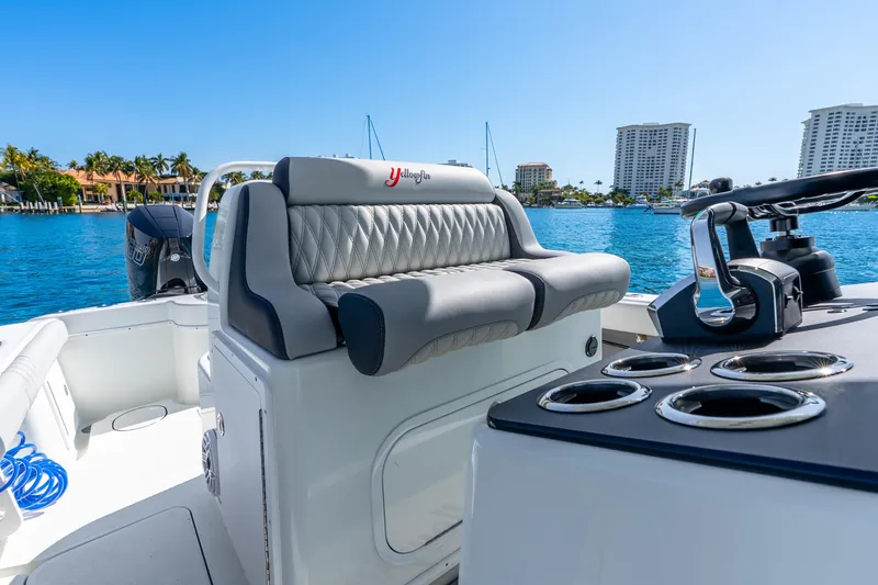 Slide: The Image of 2014 Yellowfin 29 Offshore boat interior with luxurious seating and ocean view. - 25