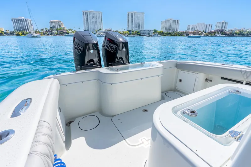 Slide: The Image of 2014 Yellowfin 29 Offshore boat with dual engines on clear blue water. - 26