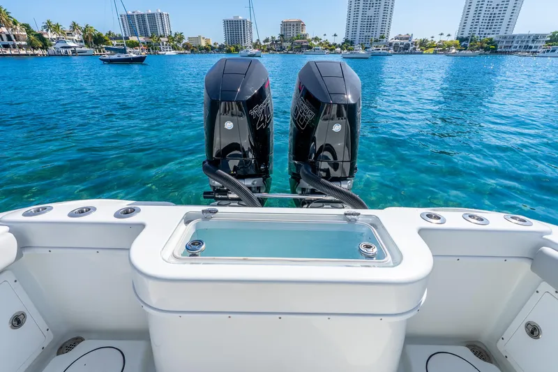 Slide: The Image of 2014 Yellowfin 29 Offshore boat with dual engines on clear blue water. - 27