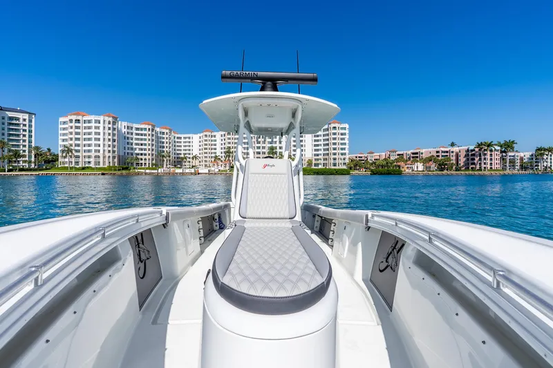 Slide: The Image of 2014 Yellowfin 29 Offshore boat on water with cityscape background. - 32