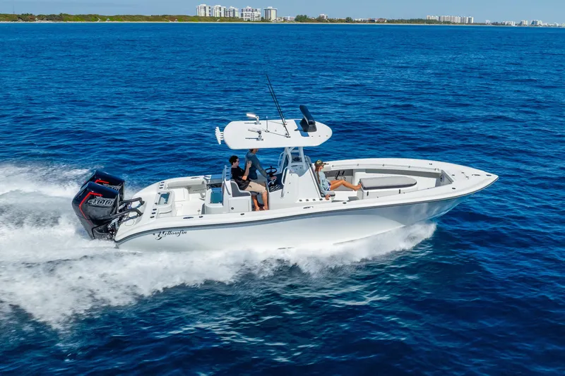 Slide: The Image of 2014 Yellowfin 29 Offshore boat cruising on open blue water. - 4