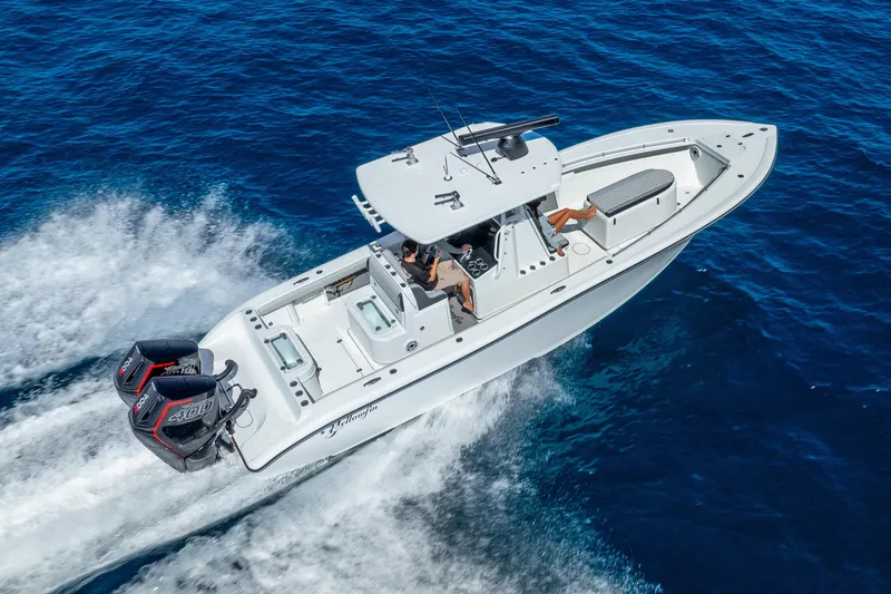 Slide: The Image of 2014 Yellowfin 29 Offshore boat cruising on open blue water. - 5