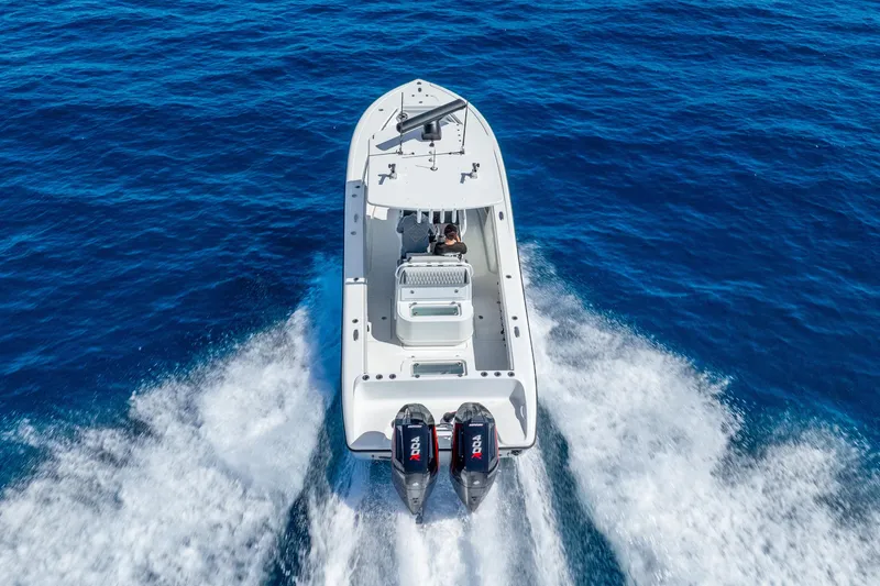Slide: The Image of 2014 Yellowfin 29 Offshore boat cruising on open blue water. - 7
