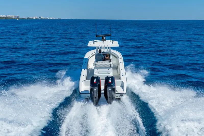 Slide: The Image of 2014 Yellowfin 29 Offshore boat cruising on open blue ocean waters. - 8