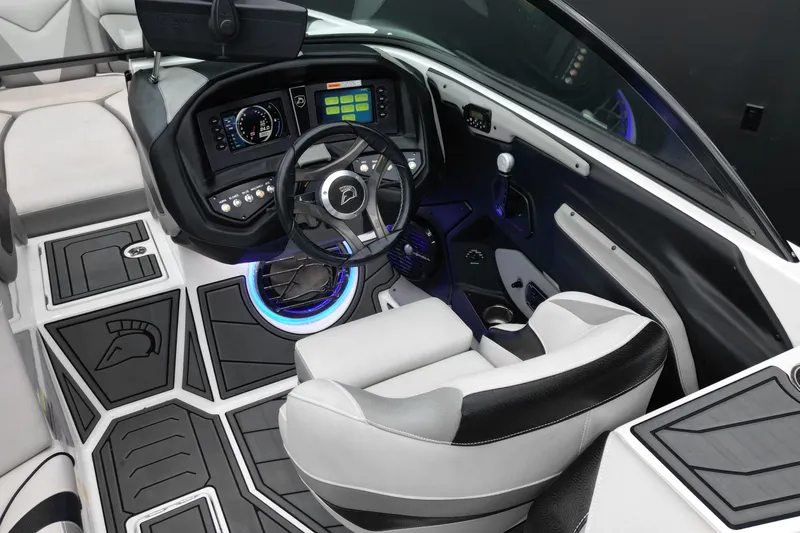 Slide: The Image of Interior of a 2017 Centurion Ri237 boat featuring a modern dashboard and steering wheel. - 12