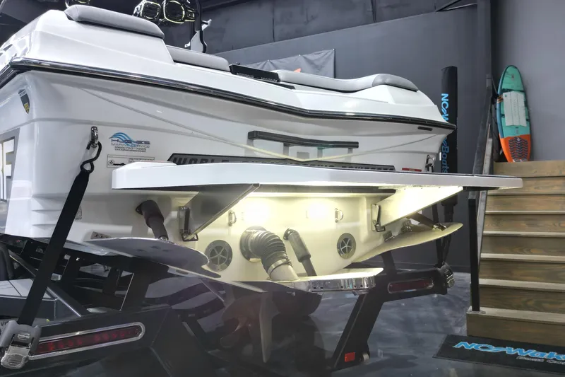 Slide: The Image of 2017 Centurion Ri237 boat rear view with illuminated swim platform in showroom. - 21