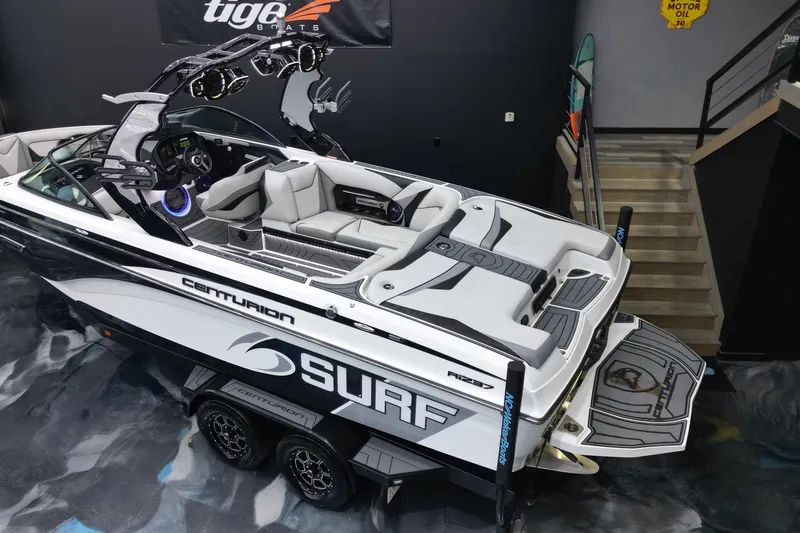 Slide: The Image of 2017 Centurion Ri237 boat with sleek design and modern interior in showroom setting. - 22