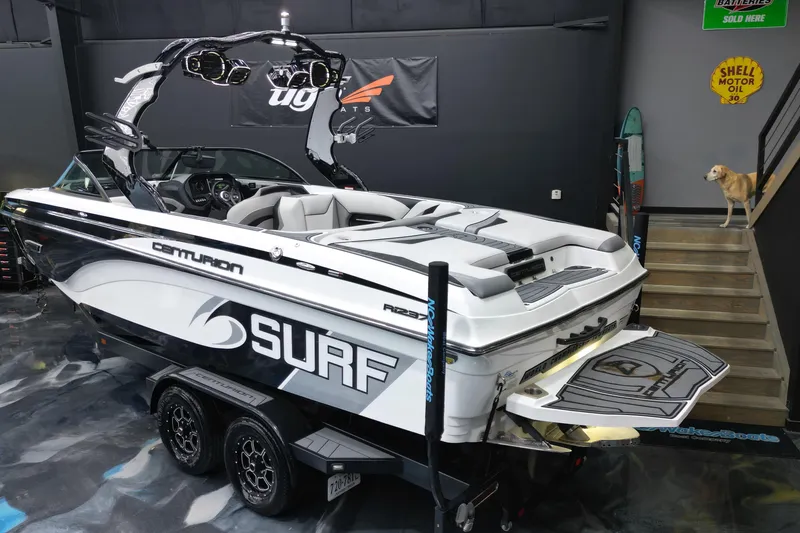 Slide: The Image of 2017 Centurion Ri237 surf boat in showroom with dog on stairs. - 23