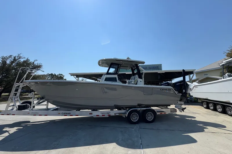 The Image of 2026 Caymas 29 CT boat on trailer in sunny outdoor setting. - 1