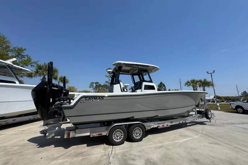 Slide: The Image of 2026 Caymas 29 CT boat on trailer under clear blue sky. - 11