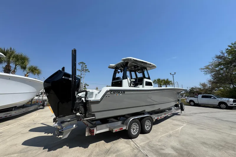 Slide: The Image of 2026 Caymas 29 CT boat on trailer under clear blue sky. - 12