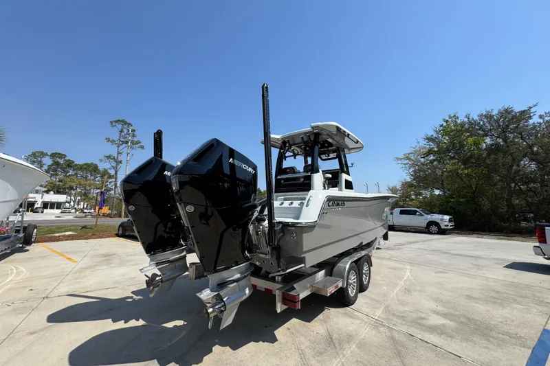 Slide: The Image of 2026 Caymas 29 CT boat with dual Mercury engines on a trailer. - 13