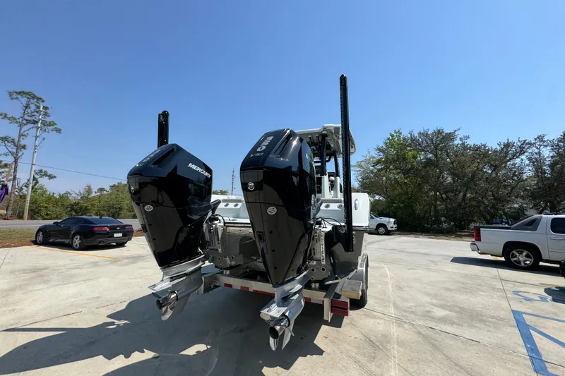 Slide: The Image of 2026 Caymas 29 CT boat with dual Mercury outboard engines in a parking lot. - 14