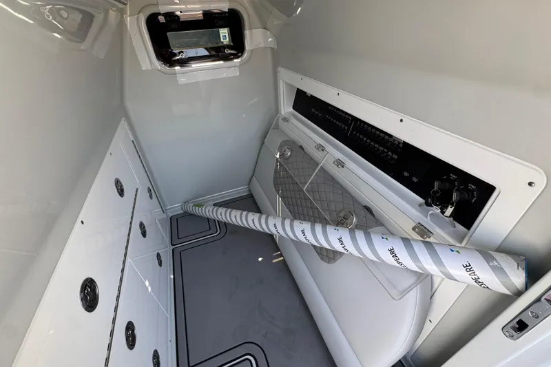 Slide: The Image of Interior of 2026 Caymas 29 CT boat, featuring storage compartments and control panel. - 27