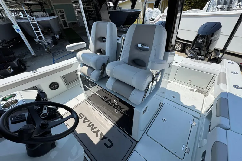Slide: The Image of Interior of 2026 Caymas 29 CT boat with modern seating and steering wheel. - 29