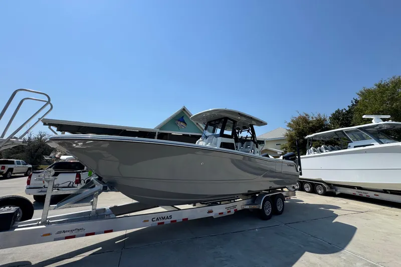 Slide: The Image of 2026 Caymas 29 CT boat on trailer under clear blue sky. - 3