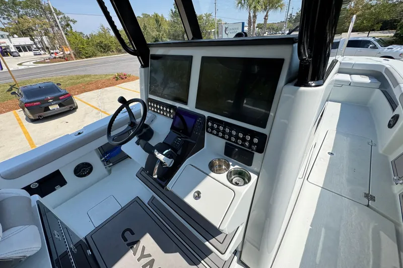 Slide: The Image of Helm of 2026 Caymas 29 CT boat with advanced navigation displays and controls. - 37