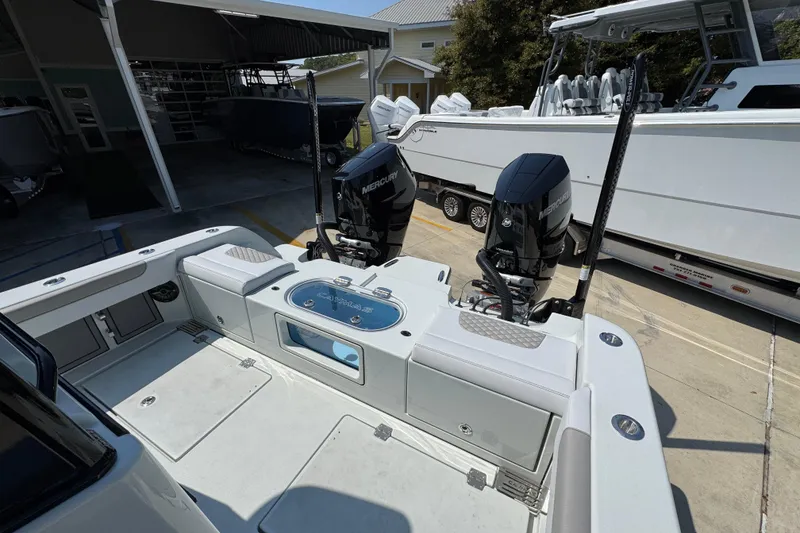 Slide: The Image of 2026 Caymas 29 CT boat with dual Mercury engines at a marina. - 42