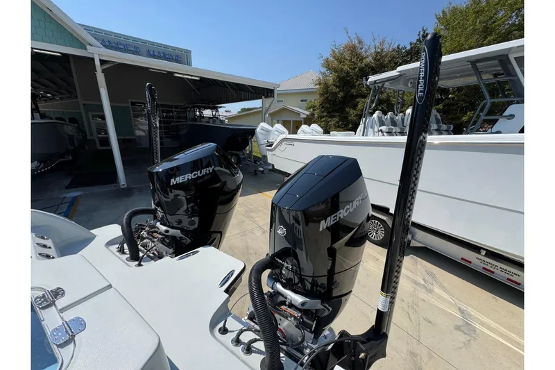 Slide: The Image of 2026 Caymas 29 CT boat with dual Mercury engines at a marina. - 44