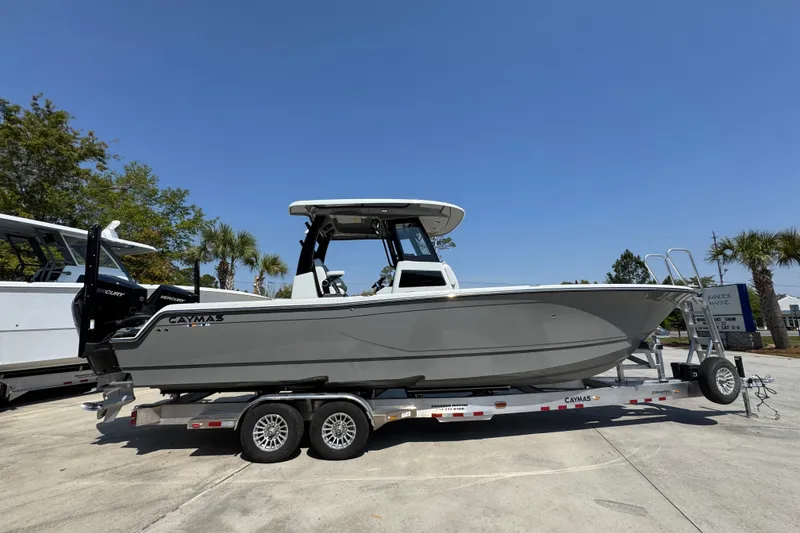 Slide: The Image of 2026 Caymas 29 CT boat on trailer under clear blue sky. - 10