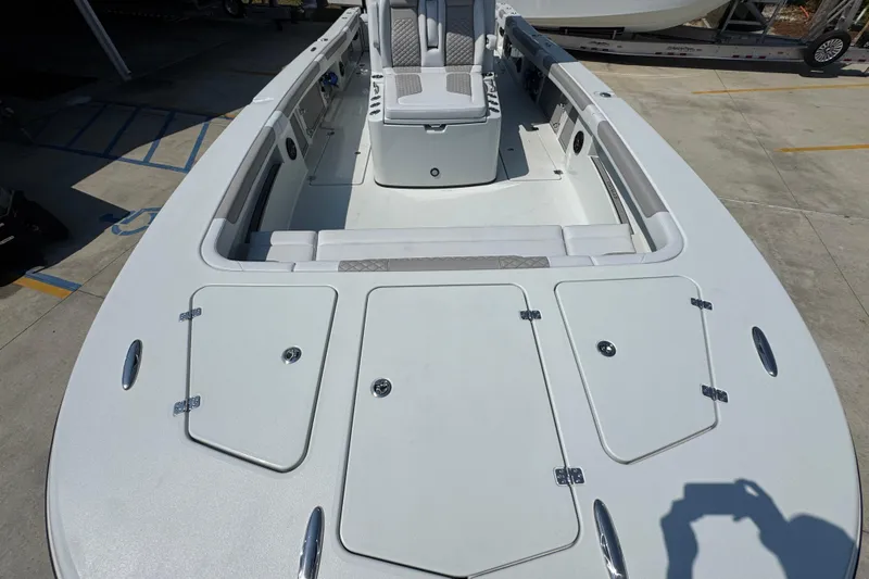 Slide: The Image of 2026 Caymas 29 CT boat deck with seating and storage compartments. - 19