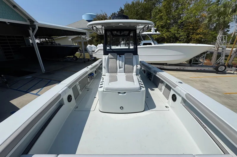 Slide: The Image of 2026 Caymas 29 CT boat with spacious deck and modern seating in a marina setting. - 21