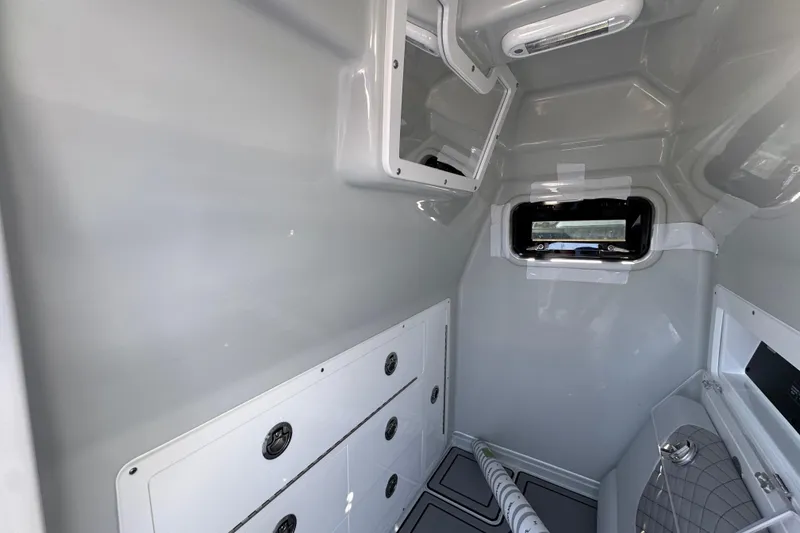 Slide: The Image of Interior cabin of 2026 Caymas 29 CT boat with storage compartments and window. - 28