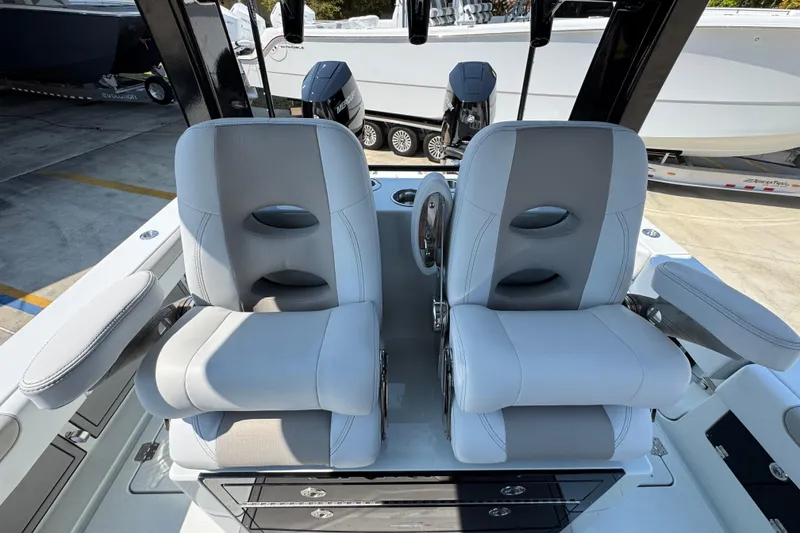Slide: The Image of 2026 Caymas 29 CT boat interior with dual captain's chairs and steering wheel. - 30