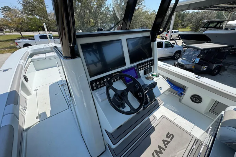 Slide: The Image of 2026 Caymas 29 CT boat cockpit with dual screens and steering wheel. - 33