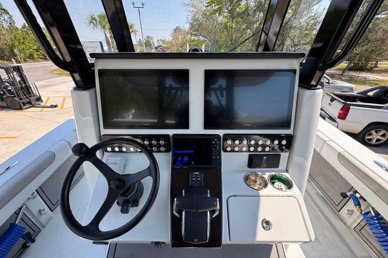 Slide: The Image of 2026 Caymas 29 CT boat dashboard with dual screens and steering wheel. - 34
