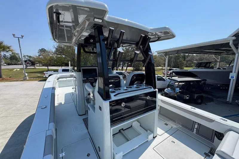 Slide: The Image of 2026 Caymas 29 CT boat with sleek design and modern console, docked outdoors. - 39