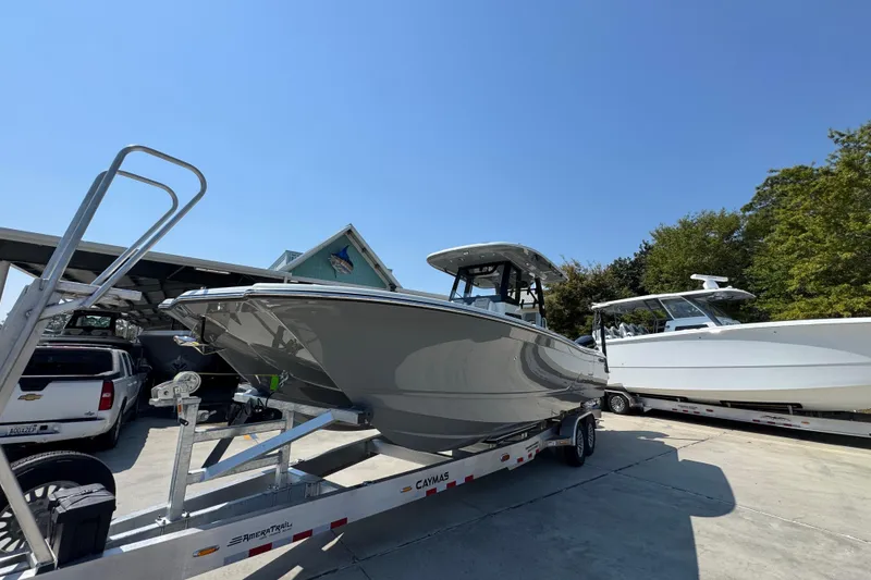 Slide: The Image of 2026 Caymas 29 CT boat on trailer under clear blue sky. - 4