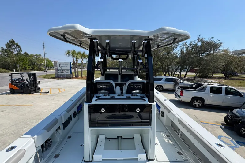 Slide: The Image of 2026 Caymas 29 CT boat with T-top, parked in a lot with vehicles nearby. - 40