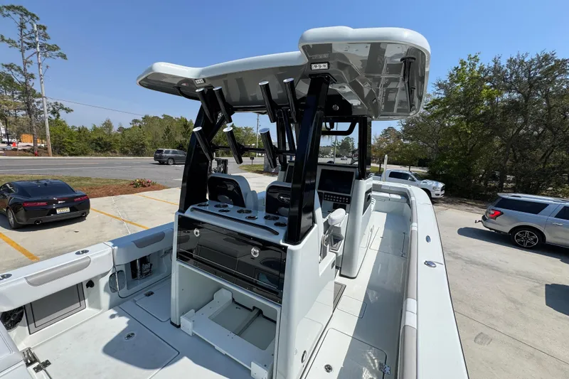 Slide: The Image of 2026 Caymas 29 CT boat with modern console and seating, parked outdoors. - 41