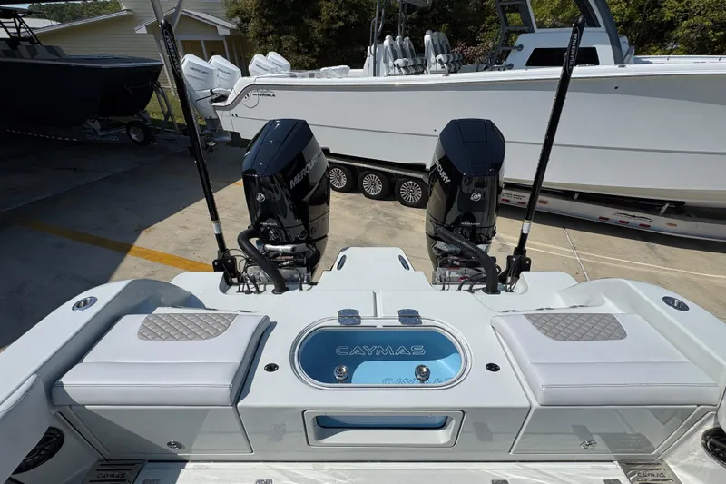 Slide: The Image of 2026 Caymas 29 CT boat with dual Mercury engines, docked outdoors. - 43