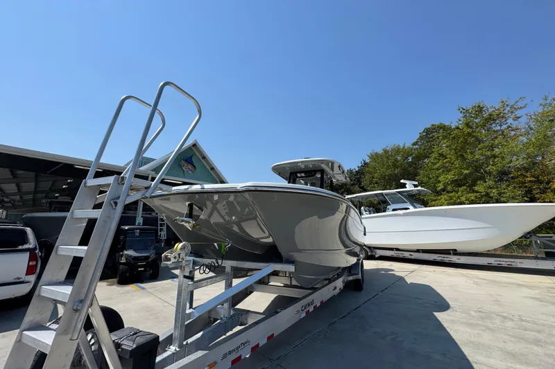 Slide: The Image of 2026 Caymas 29 CT boat on trailer under clear blue sky. - 5