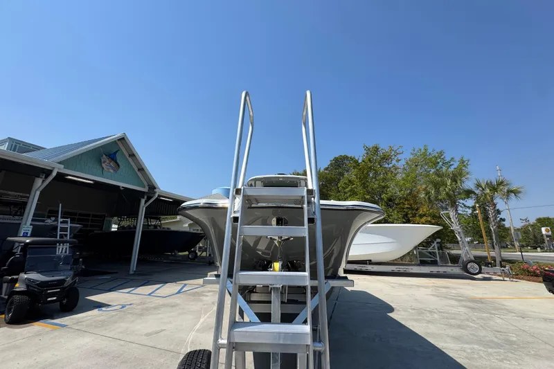 Slide: The Image of 2026 Caymas 29 CT boat on trailer with ladder, outdoor dealership setting. - 6